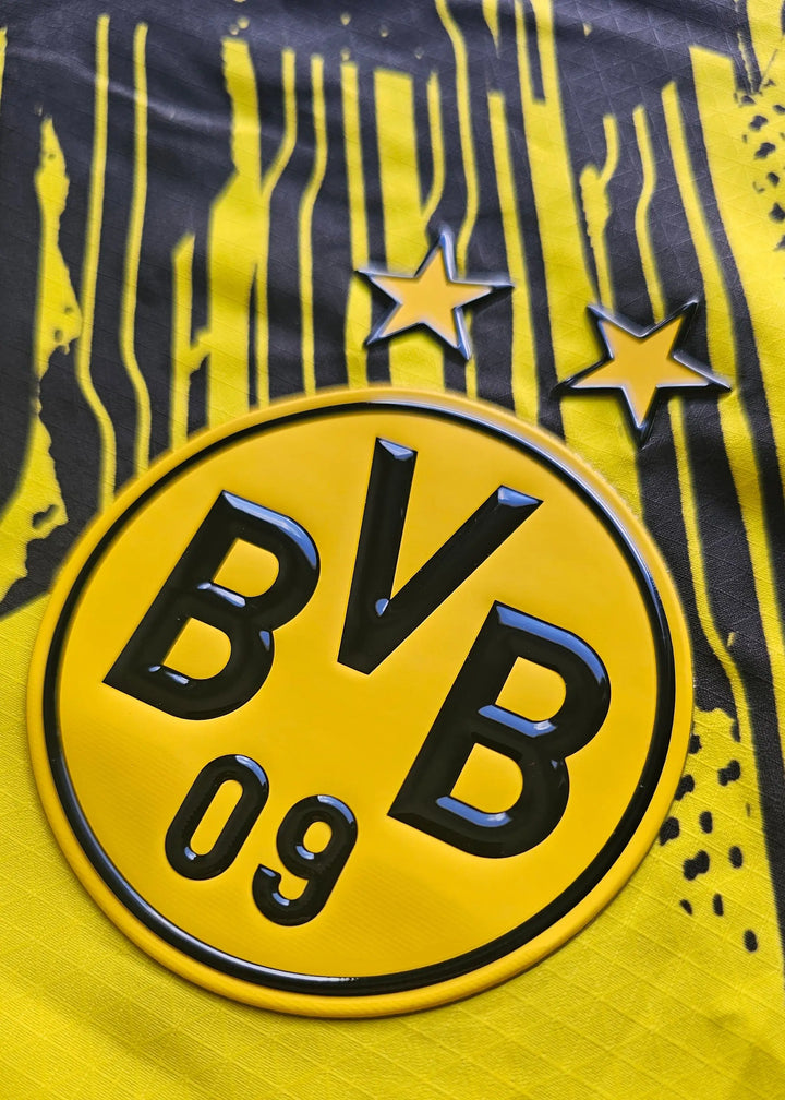 The BVB 09 crest and its two championship stars sit on the Borussia Dortmund shirt's striped yellow and black pattern.