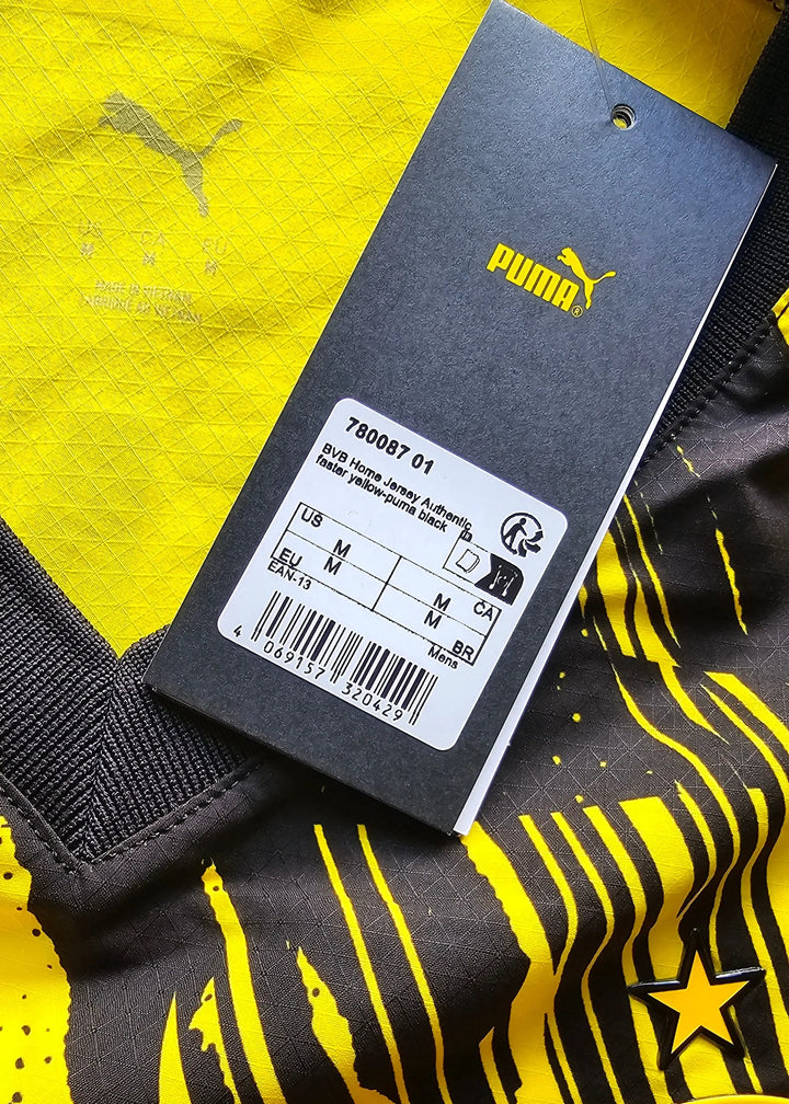 Yellow Borussia Dortmund shirt detail featuring the Puma logo and care tag.