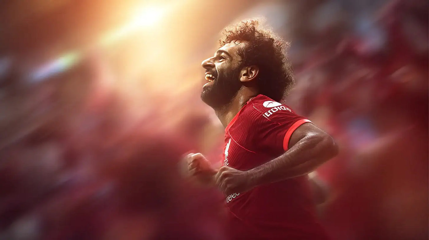 Mohamed Salah in Liverpool red kit smiling and sprinting through sunlit motion blur after scoring.