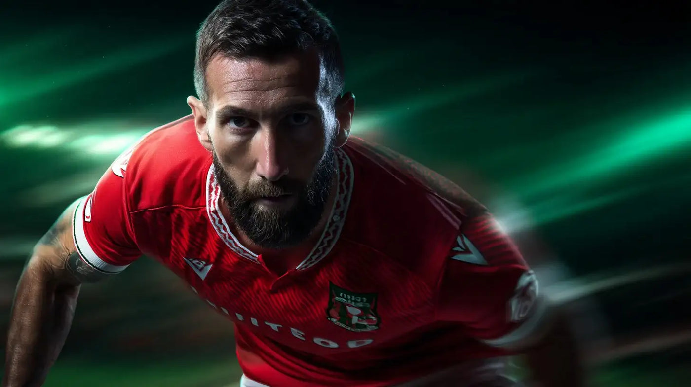 Ollie Palmer in Wrexham AFC red kit crouched low and focused against a green-tinted motion background.