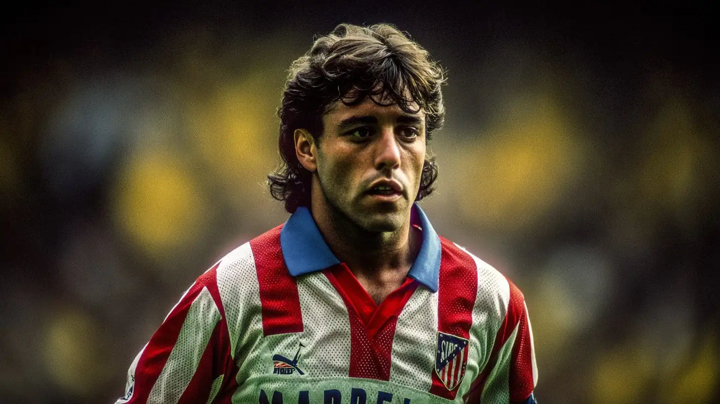 Paolo Futre in Atletico Madrid red and white striped football shirt with blue collar and club crest, standing on the pitch during a match.