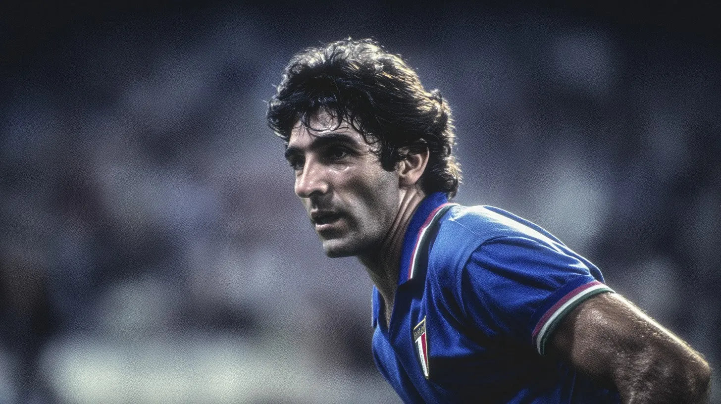 Paolo Rossi in Italy 1982 blue kit watching play intently during a World Cup match.
