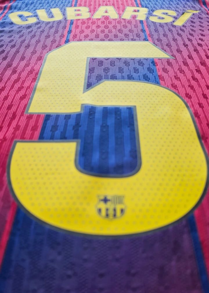 Close-up of an FC Barcelona shirt back, CUBARSÍ above No. 5 in yellow, on red-and-blue striped fabric.