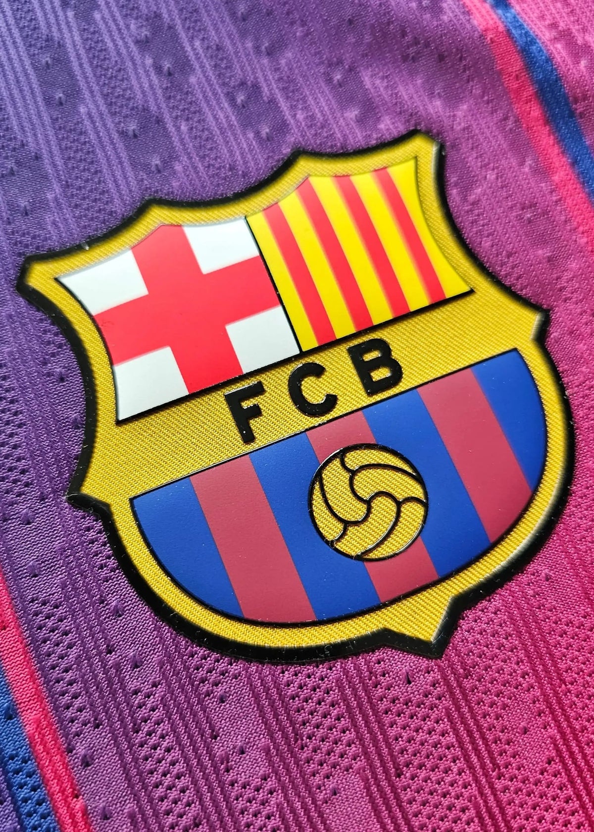 FC Barcelona's red-and-blue striped club crest with the Catalan cross and 'FCB' lettering, on Pau Cubarsí's 2025-2026 shirt, No. 5.