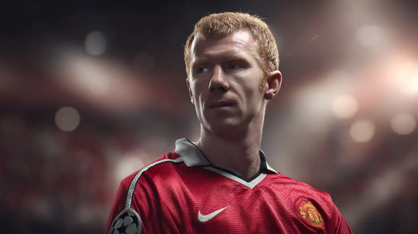 Paul Scholes in Manchester United home shirt looking to the side under soft Old Trafford lights.
