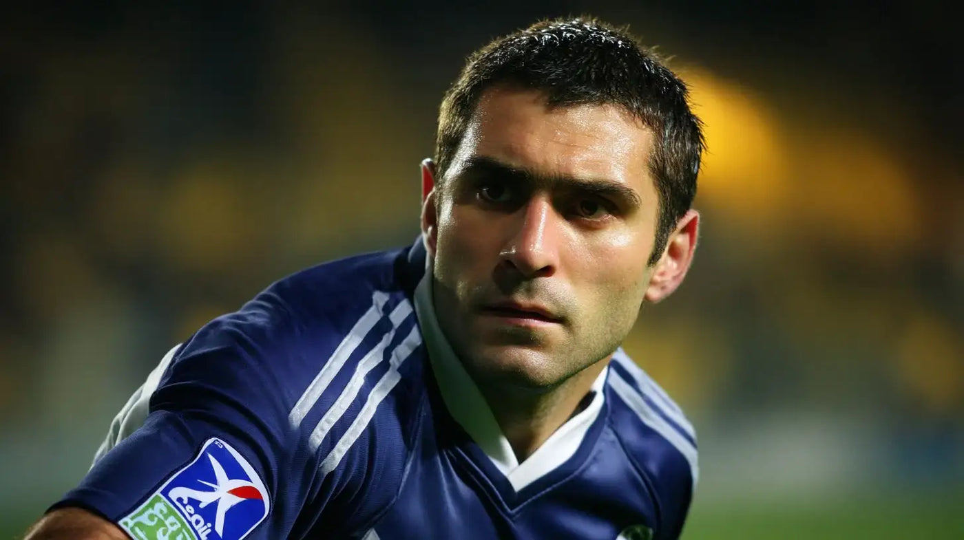 Pauleta in Girondins de Bordeaux navy football shirt with white shoulder stripes and sponsor patch during a night match.