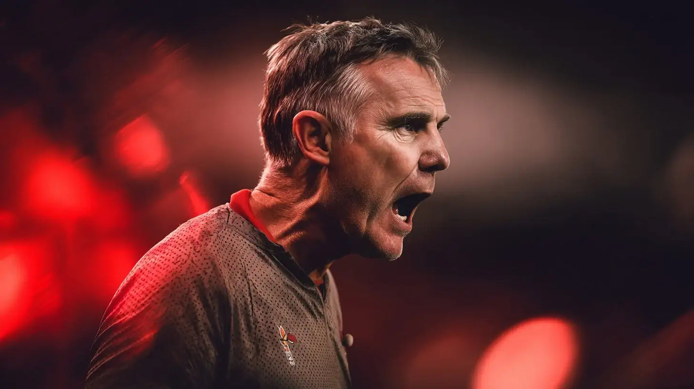 Wrexham AFC manager Phil Parkinson shouting instructions on the touchline under dramatic red stadium lights.