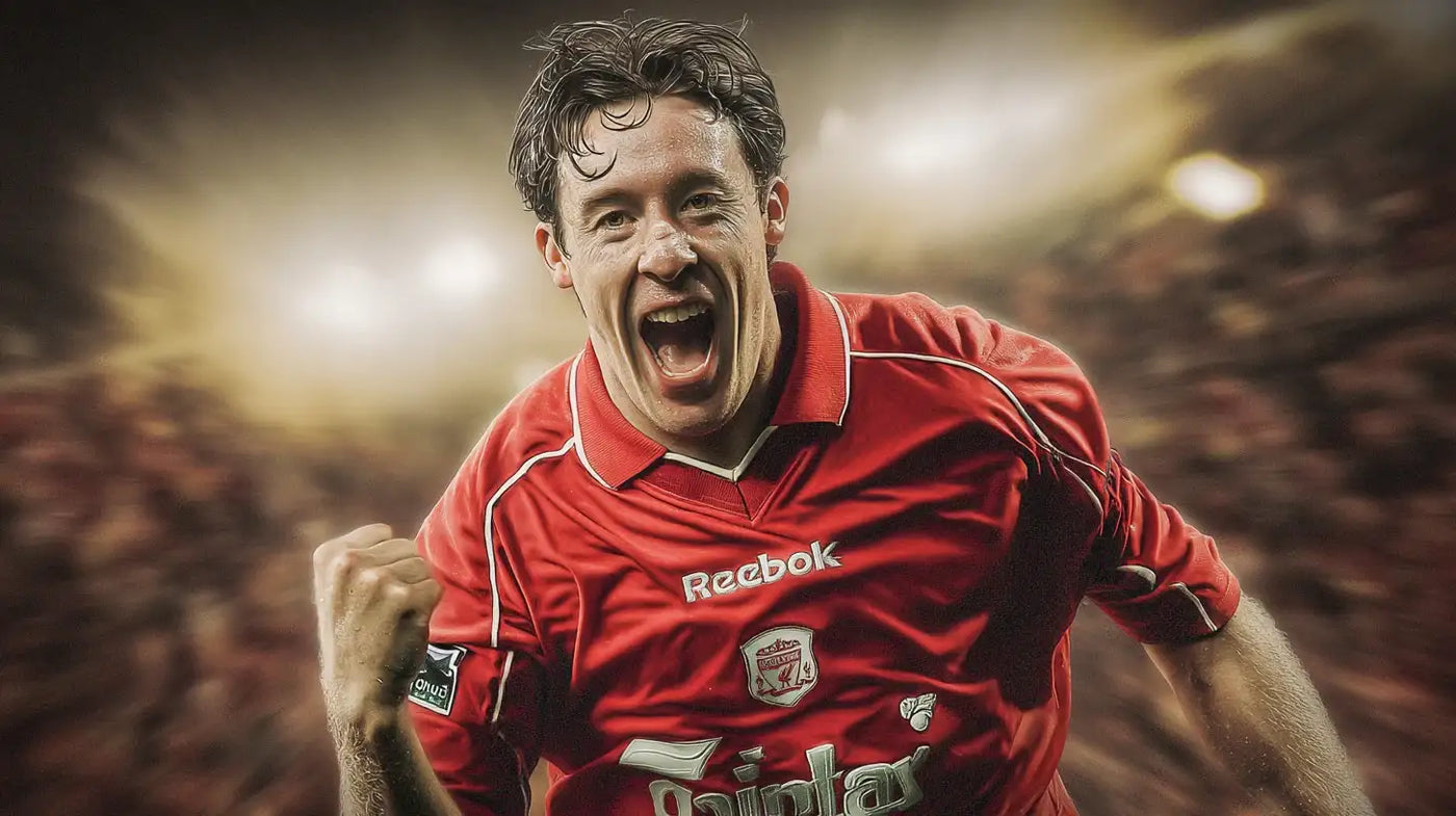 Robbie Fowler of Liverpool celebrates with a clenched fist while wearing a red football shirt with Reebok sponsor.