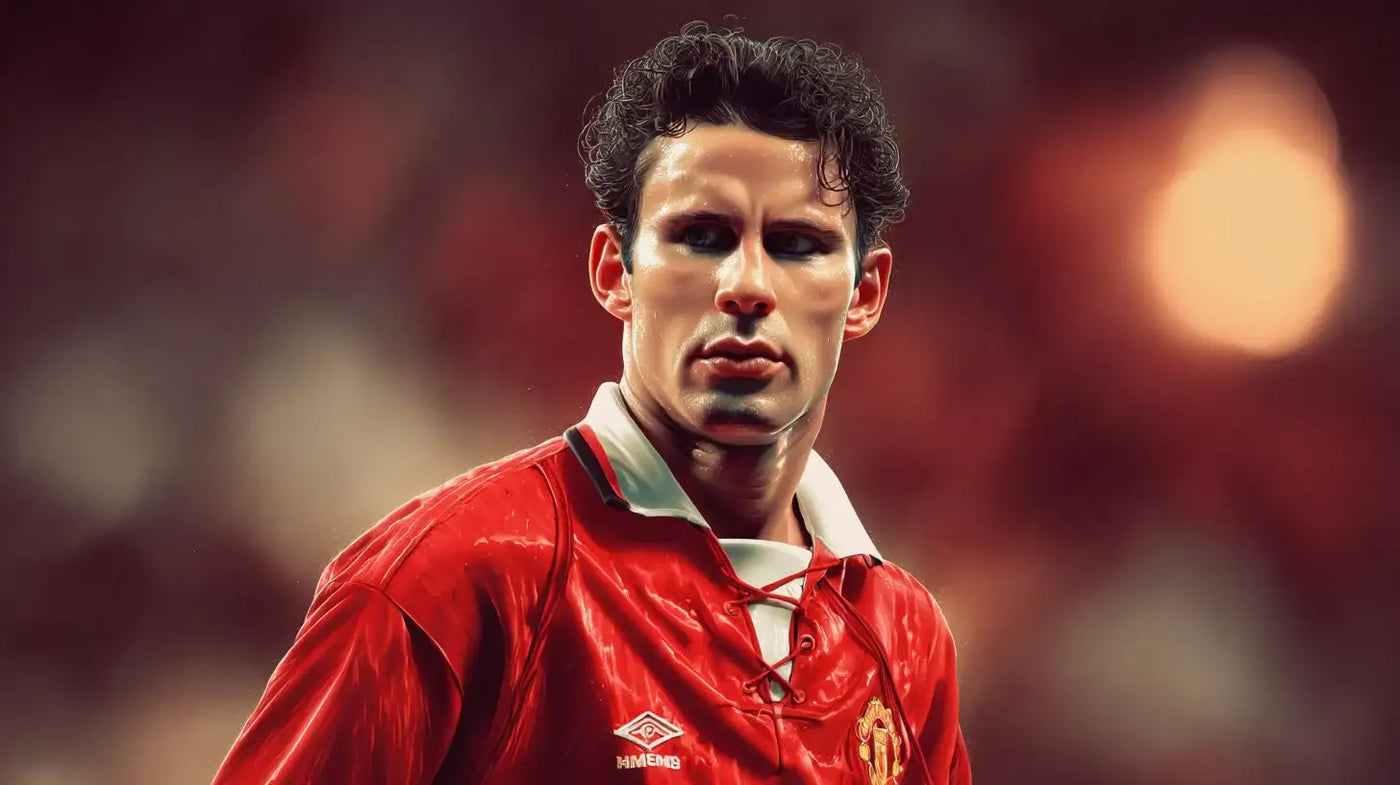 Close up of Ryan Giggs in a red Manchester United home football shirt, staring ahead under soft stadium lights.