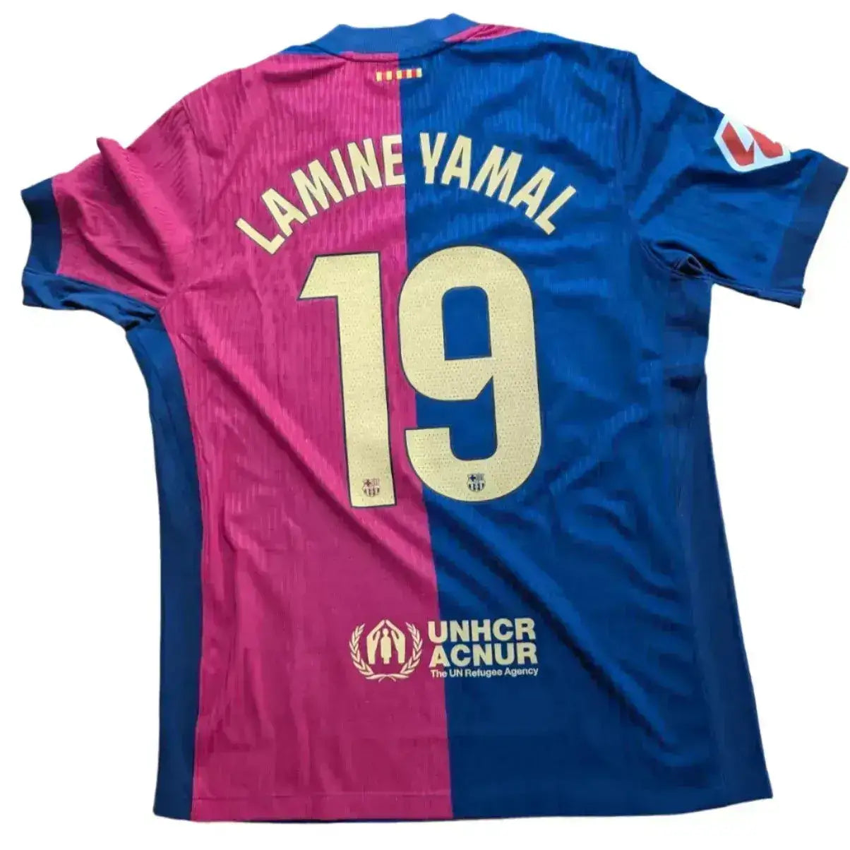 Back view featuring Lamine Yamal, No. 19, and UNHCR logo on a blue and pink football shirt.