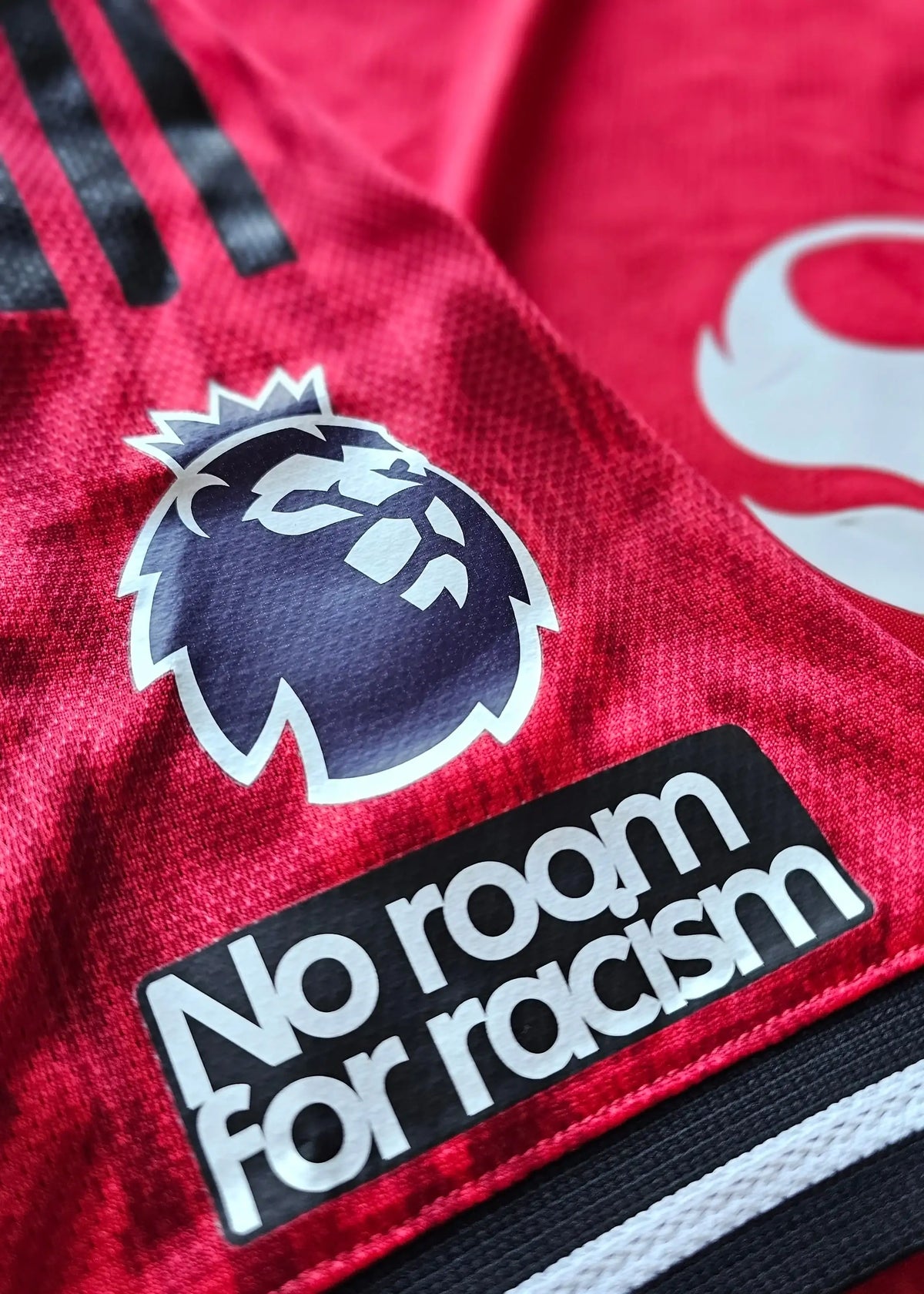 Premier League badge and No room for racism sleeve patch on Tyler Fletcher's Manchester United F.C. Signed shirt.