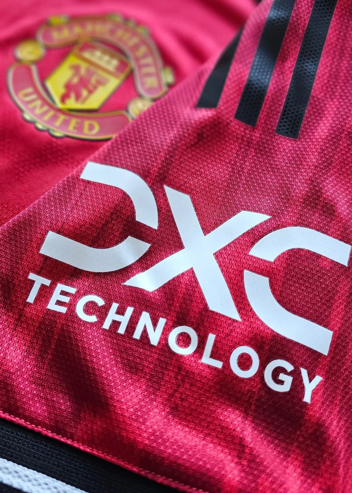 Manchester United crest and DXC Technology sponsor logo on Tyler Fletcher's Manchester United F.C. Signed shirt.