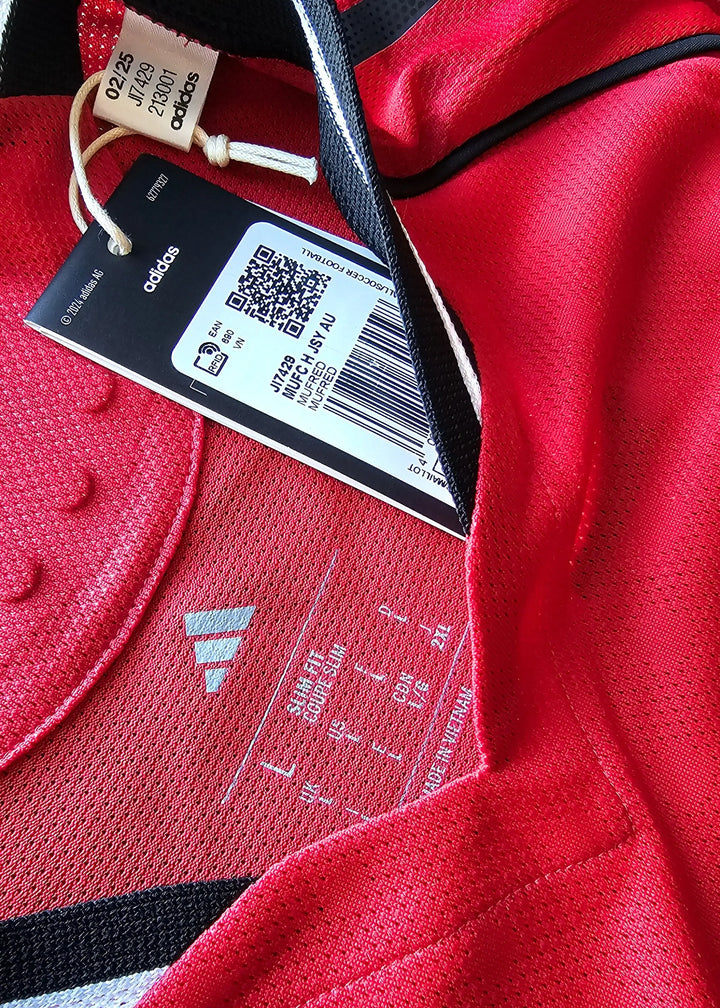 Interior view featuring adidas logo and care label; red fabric with black accents.
