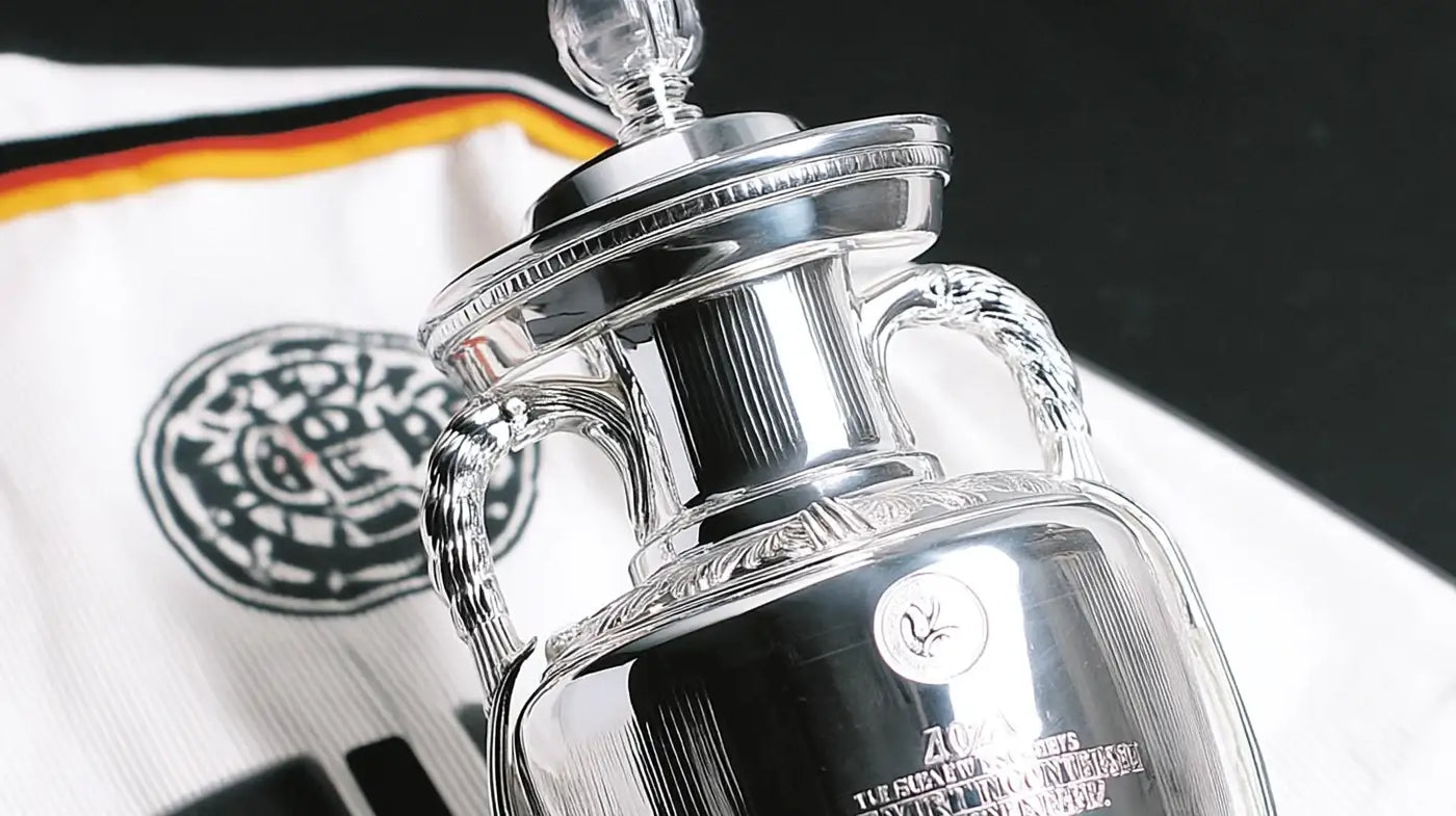 European Championship trophy with green and yellow backdrop, echoing West Germany’s success at Euro 1980.