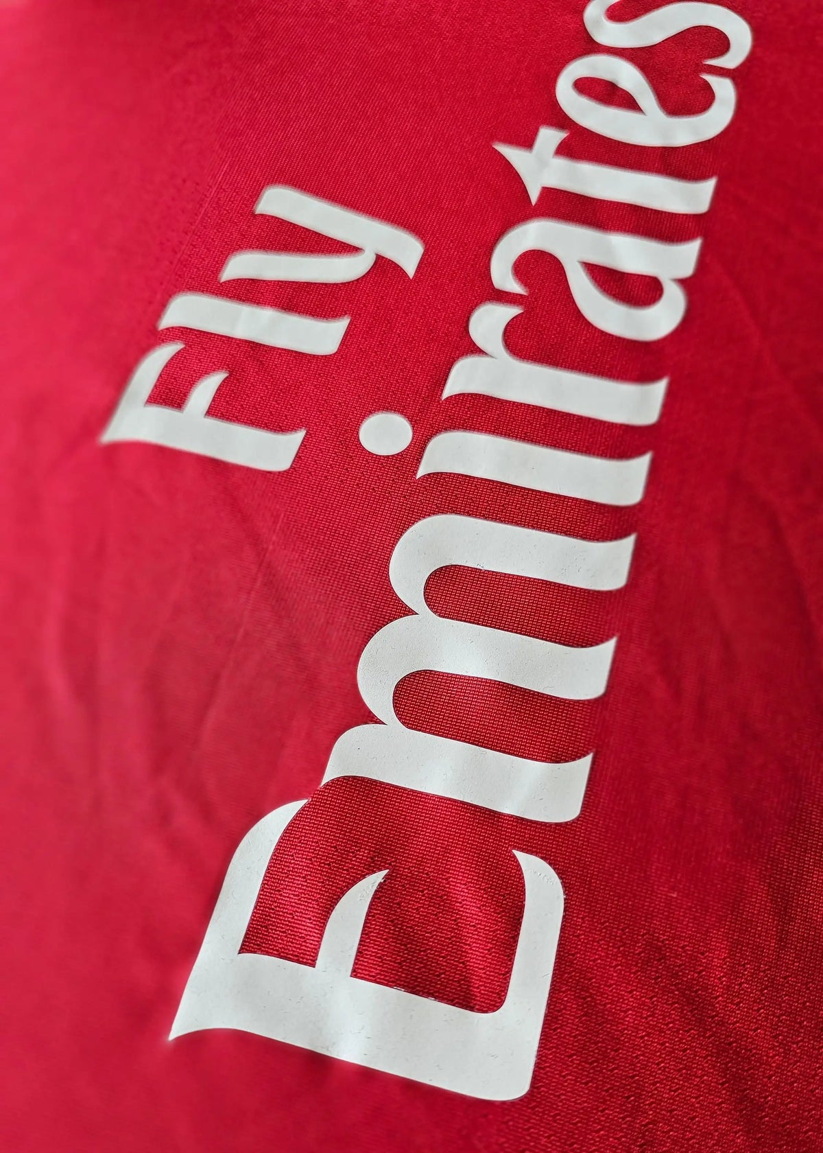 Fly Emirates sponsor print in white lettering on the red chest, from Robin van Persie's signed Arsenal 2010-11 No. 10 shirt.