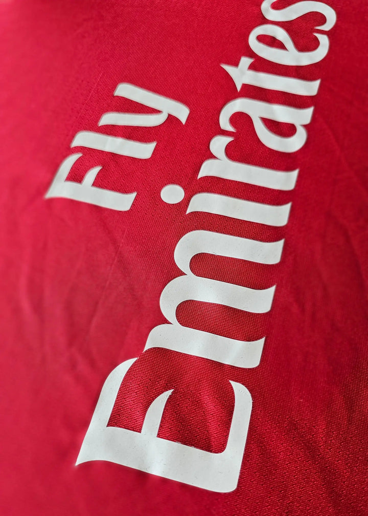 Fly Emirates sponsor print in white lettering on the red chest, from Robin van Persie's signed Arsenal 2010-11 No. 10 shirt.