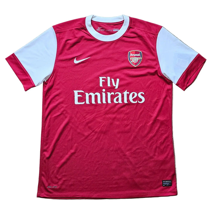 Arsenal home shirt laid flat with Nike swoosh, club crest and Fly Emirates on the chest, Robin van Persie's signed 2010-11 No. 10 shirt.