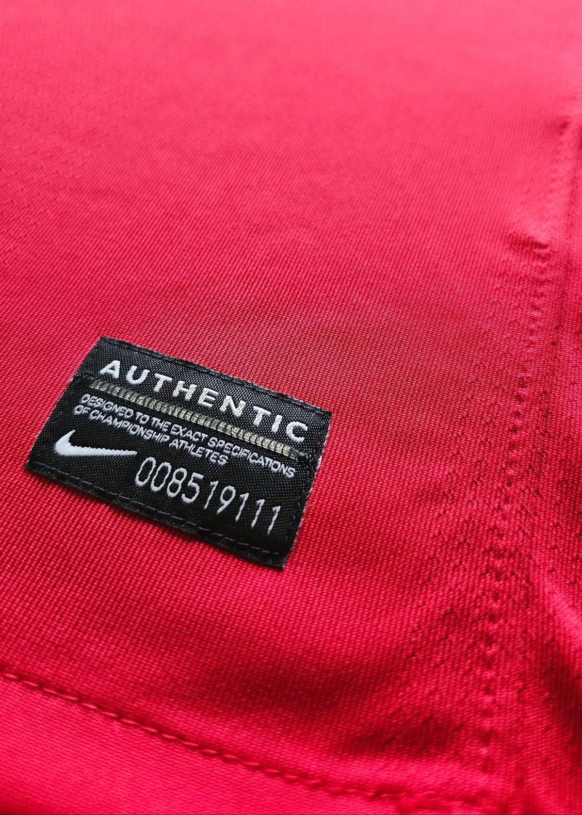 Nike Authentic tag at the hem with serial 008519111, on Robin van Persie's signed Arsenal 2010-11 No. 10 shirt.