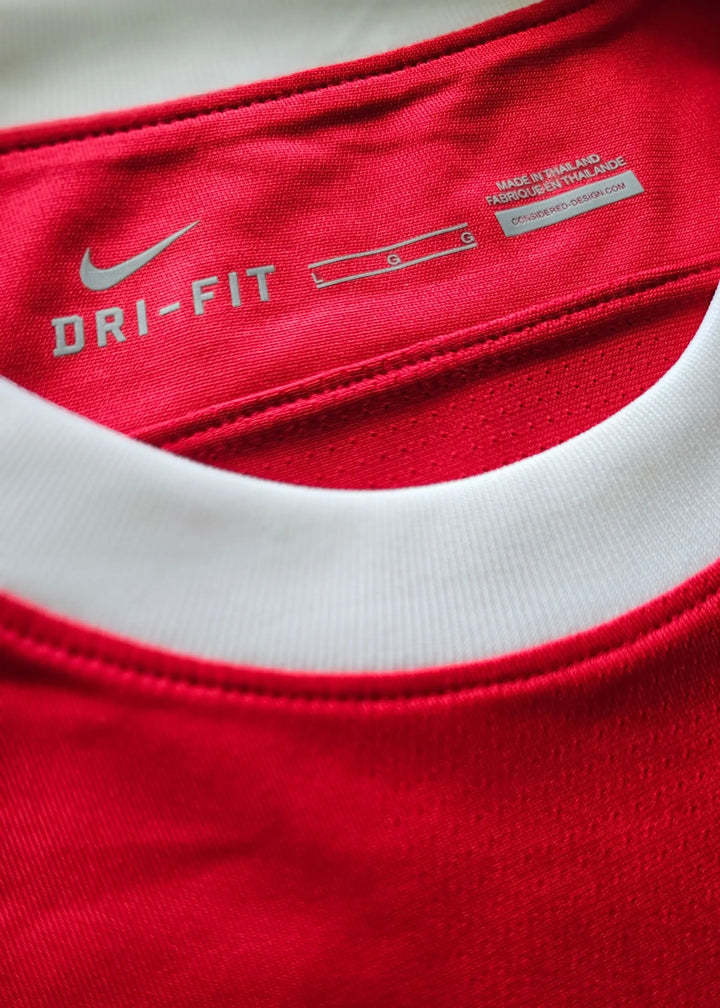 Nike DRI-FIT neck tag reading size L and Made in Thailand, inside Robin van Persie's signed Arsenal 2010-11 No. 10 shirt collar.