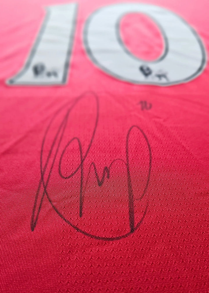 Close-up of a black-ink signature beneath the white No. 10, on Robin van Persie's signed Arsenal 2010-11 shirt back.