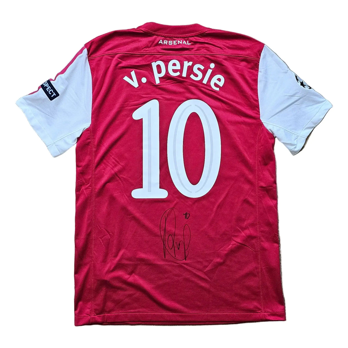 Back of a red and white Arsenal Champions League shirt with the v. persie nameplate, number 10, a Respect patch, and a signed autograph below.