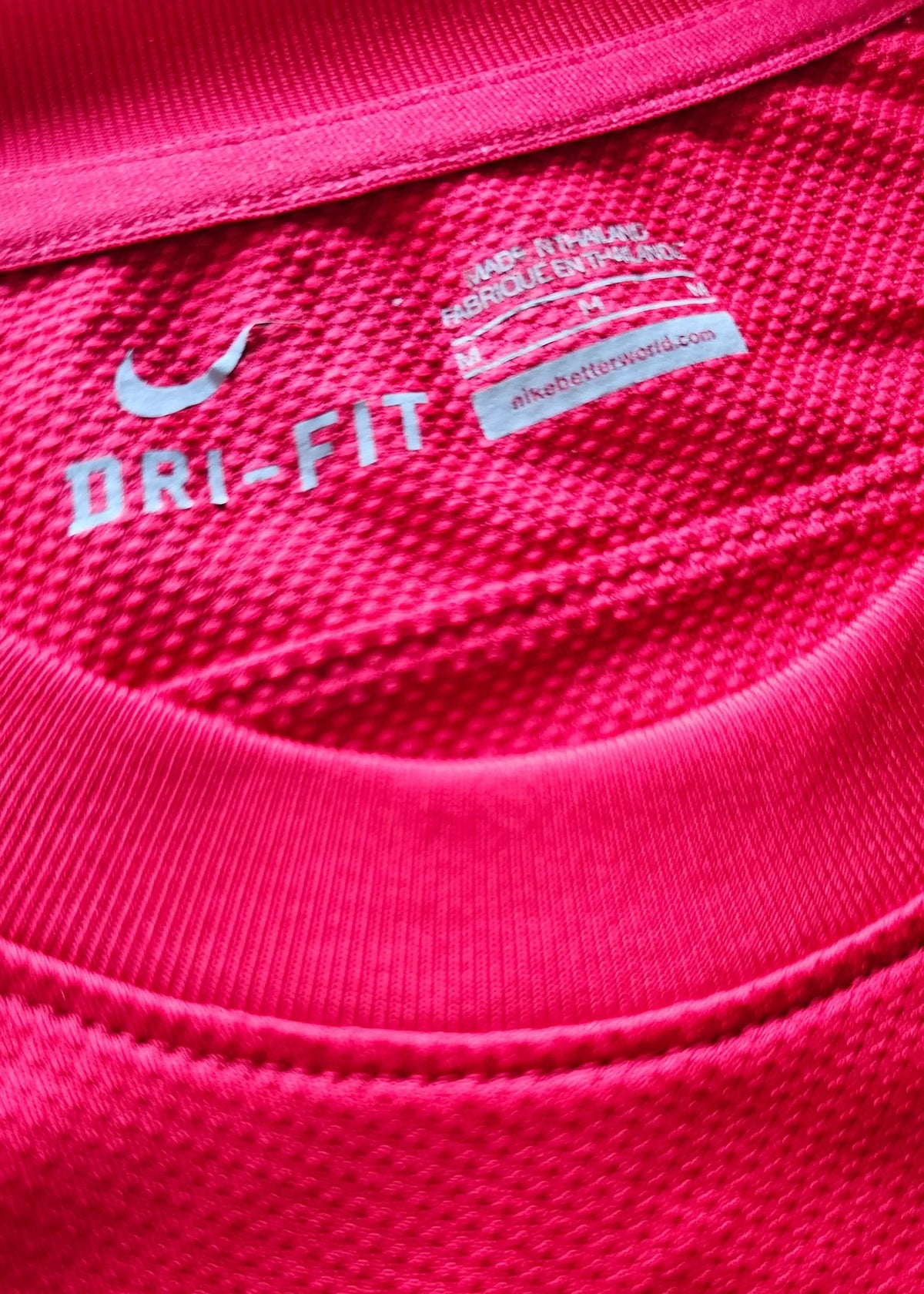 Nike DRI-FIT neck tag reading Made in Thailand and size M, inside Robin van Persie's signed Arsenal 2011-12 Champions League No. 10 shirt.