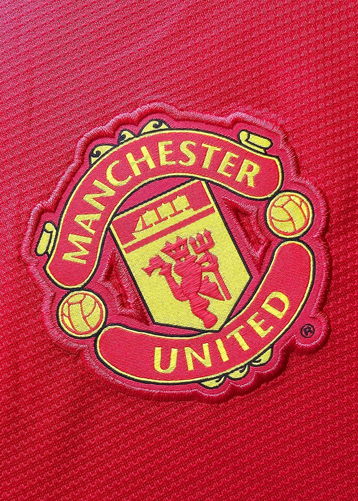 Manchester United crest with the red devil emblem embroidered on the chest, from Robin van Persie's signed 2014-15 No. 20 shirt.