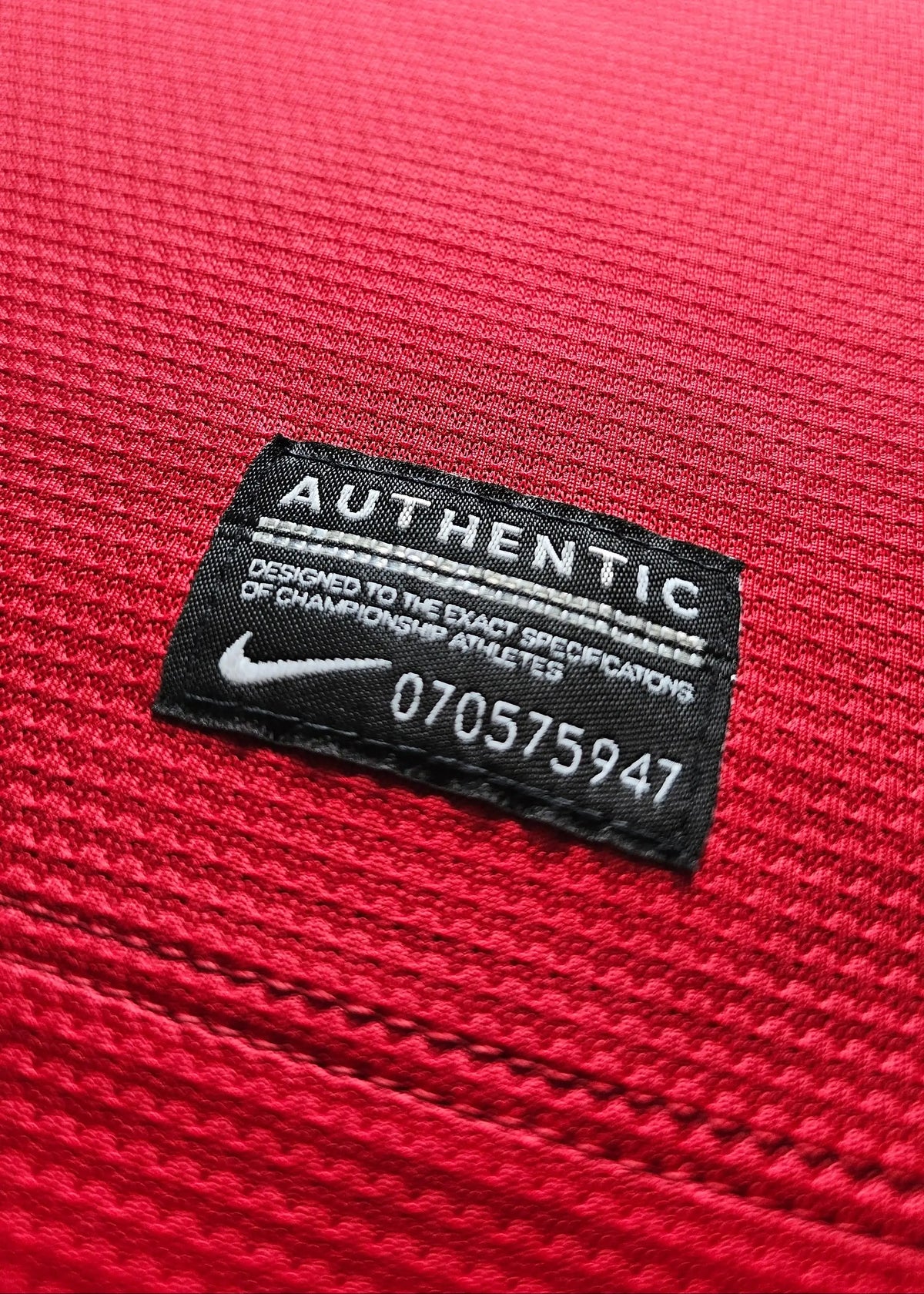 Nike Authentic tag at the hem with serial 070575947, on Robin van Persie's signed Manchester United 2014-15 No. 20 shirt.