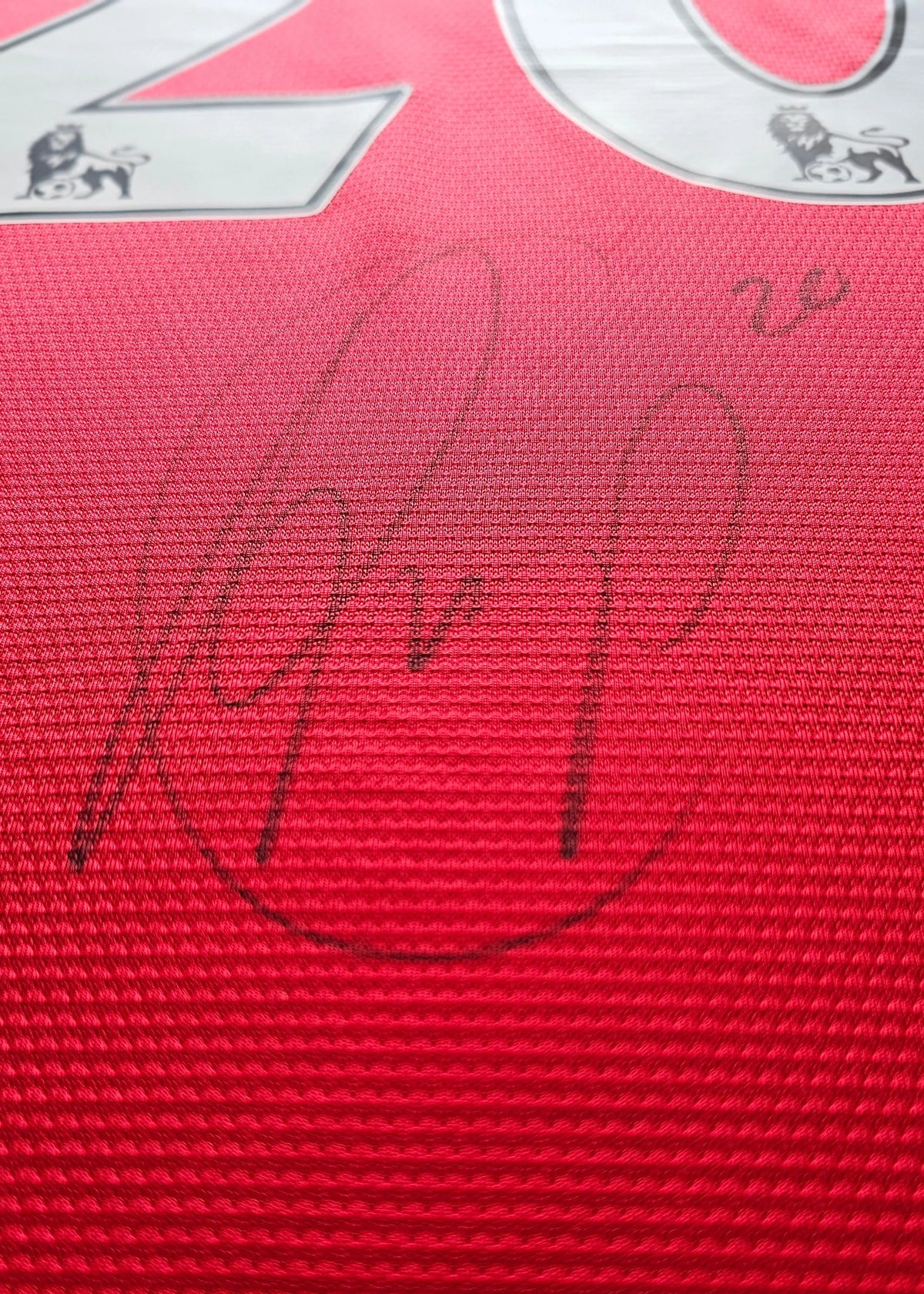 Closer view of the signature and Premier League crest on the Van Persie Manchester United shirt.