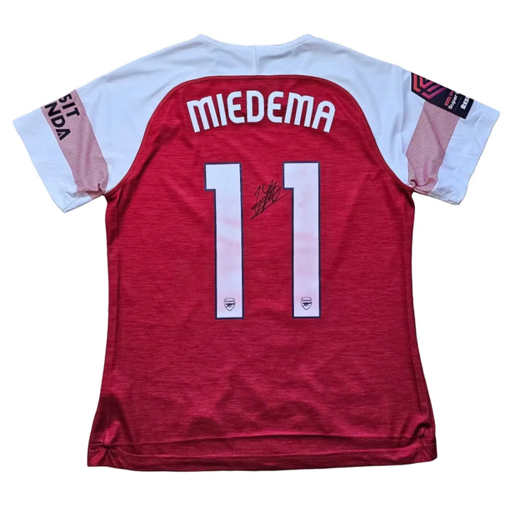 Back view of signed football shirt with Miedema and No. 11 in white lettering on red fabric.